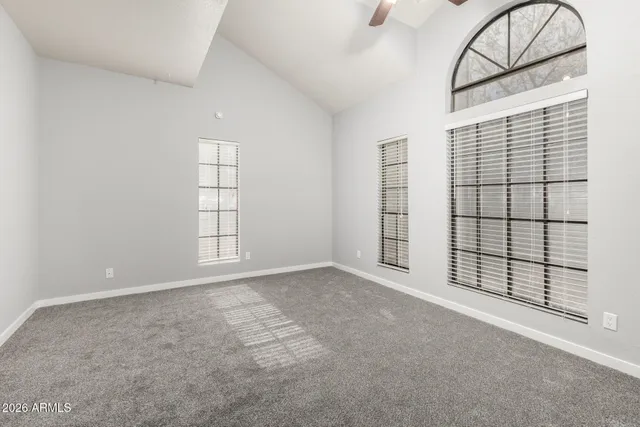 an empty room with windows and closet