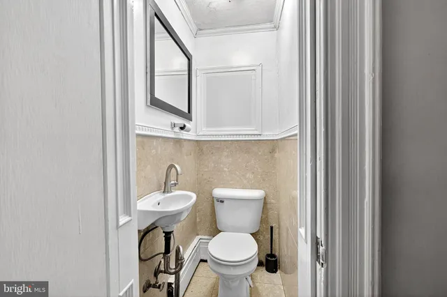 a view of staircase with wooden floor and white walls