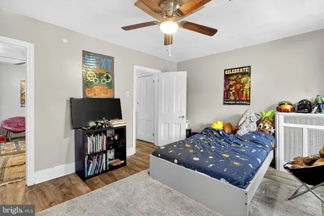 a bed room with a bed and a flat tv screen