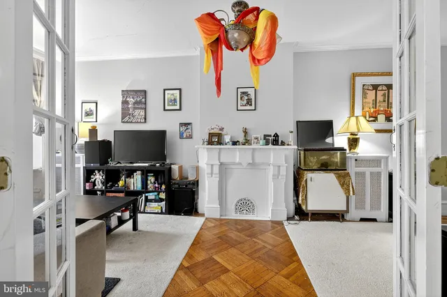 a living room with furniture a rug and a chandelier