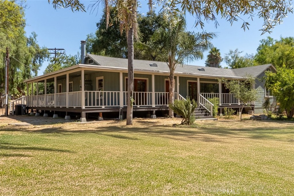 30824 Valley Center Road Valley Center, CA 92082 - Photo 1 of 1 a front view of a house with a garden