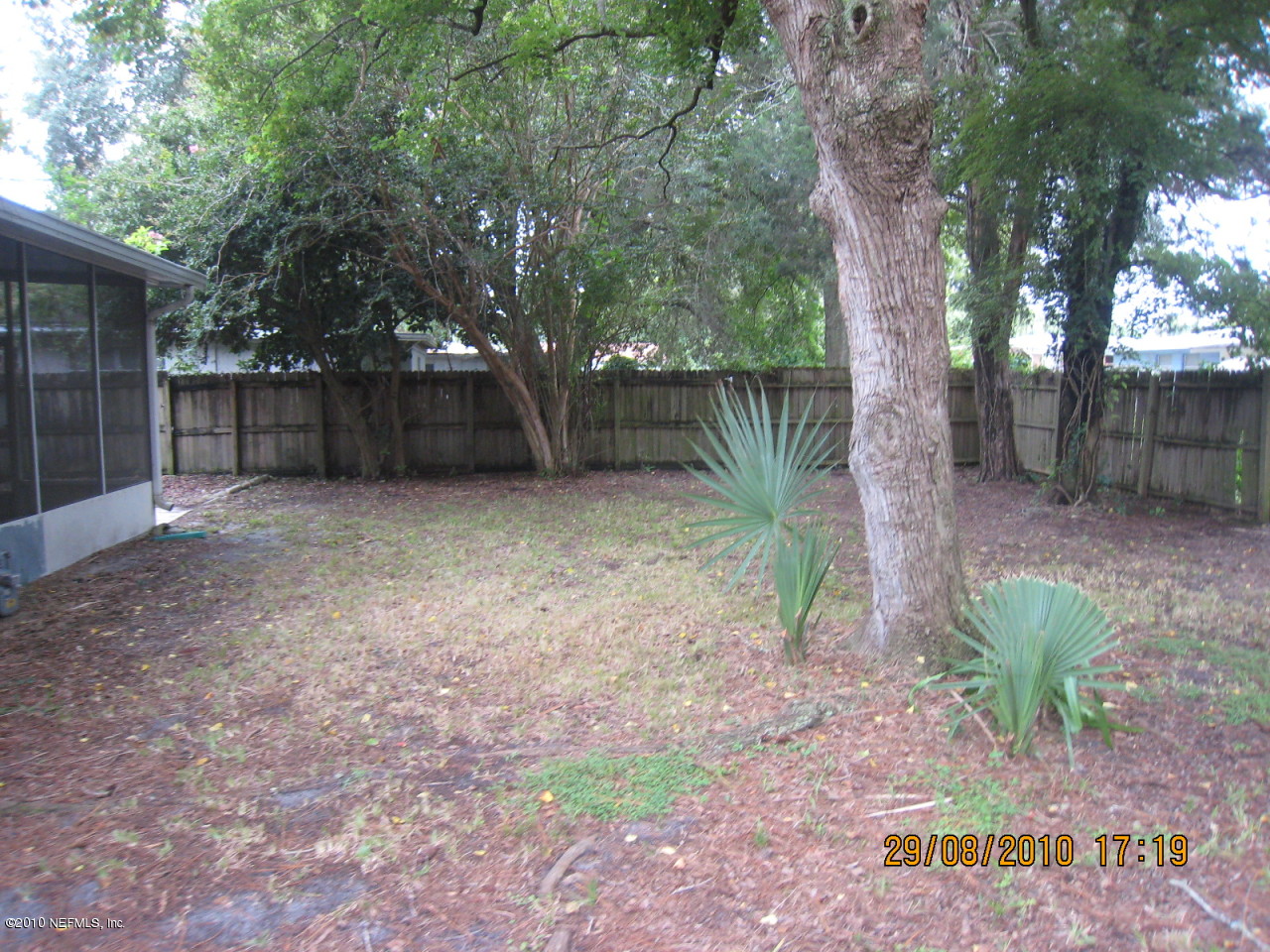 4804 Andromeda Road Jacksonville, FL 32210 - Photo 3 of 8 a backyard of a house with lots of green space