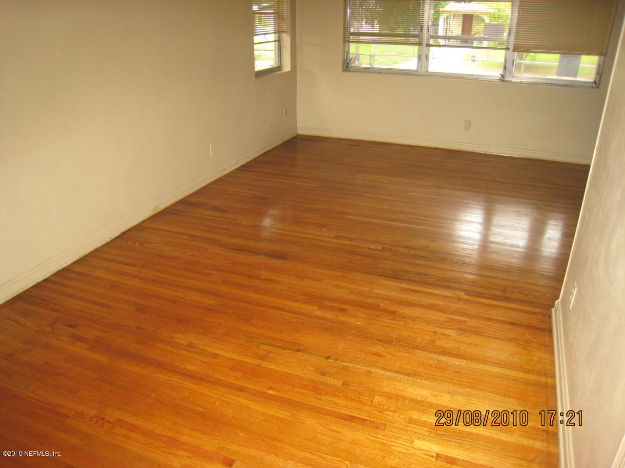 4804 Andromeda Road Jacksonville, FL 32210 - Photo 6 of 8 a view of an empty room with wooden floor and a window