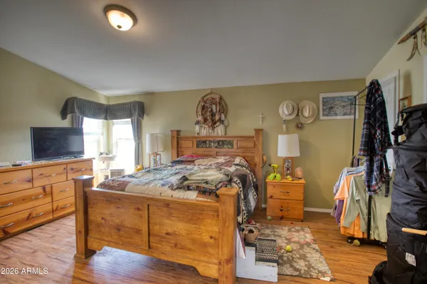 a bed room with a bed and a flat screen tv