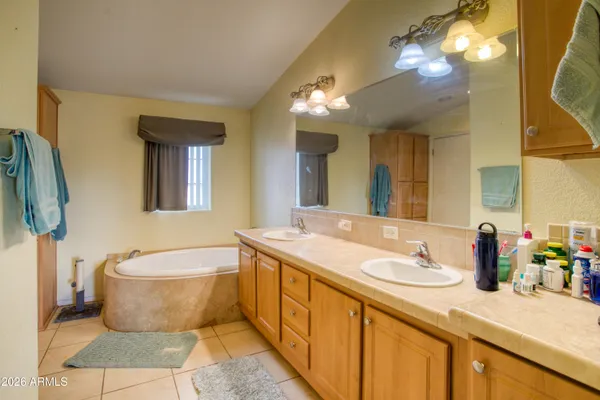 a spacious bathroom with a granite countertop sink and a mirror