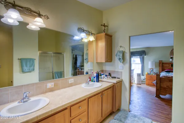 a bathroom with a double vanity sink and a mirror