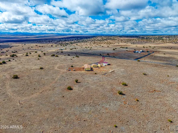 a bathroom with a granite countertop sink a toilet a mirror and bathtub