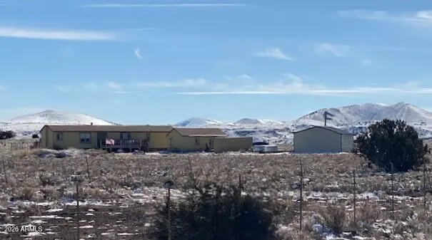 a view of a house with a yard and a lot of car