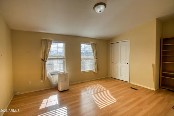 a view of a house with wooden fence