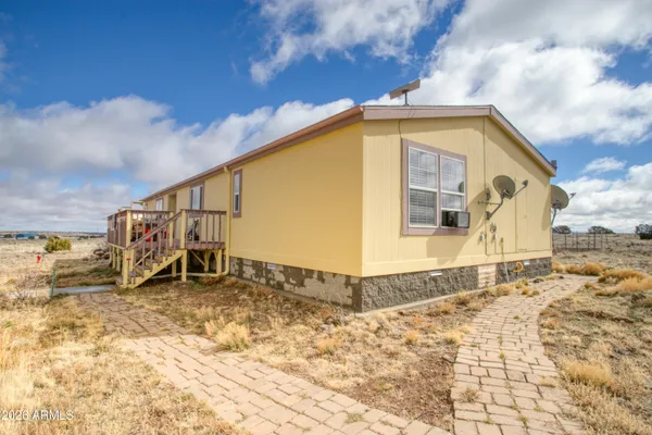 a view of a house with a snow in the background