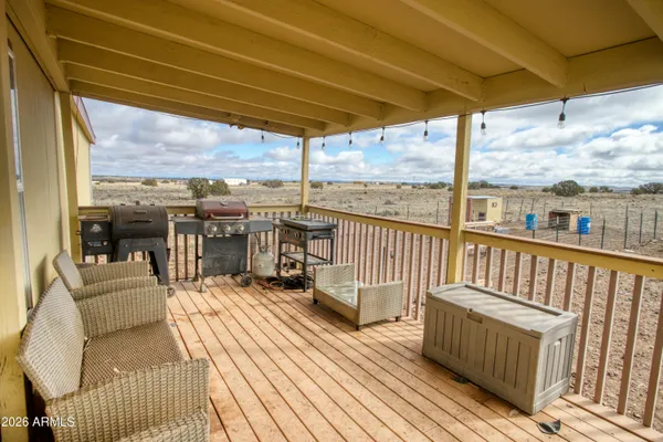 a view of a balcony with couch and wooden floor