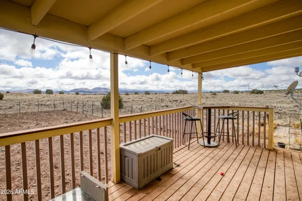 a view of a balcony with wooden floor