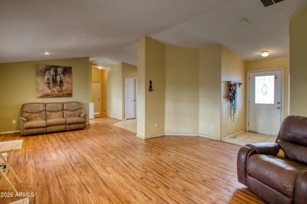 a bedroom with furniture and a wooden floor