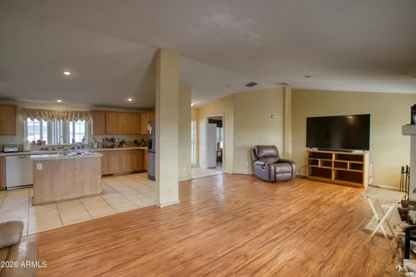 a view of a living room kitchen with furniture and a flat screen tv
