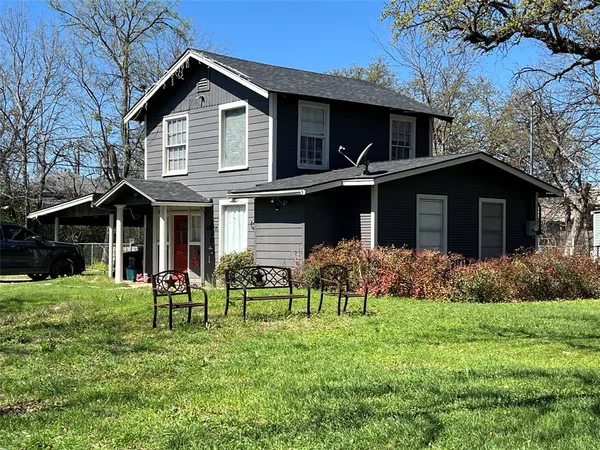 a front view of house with yard and green space