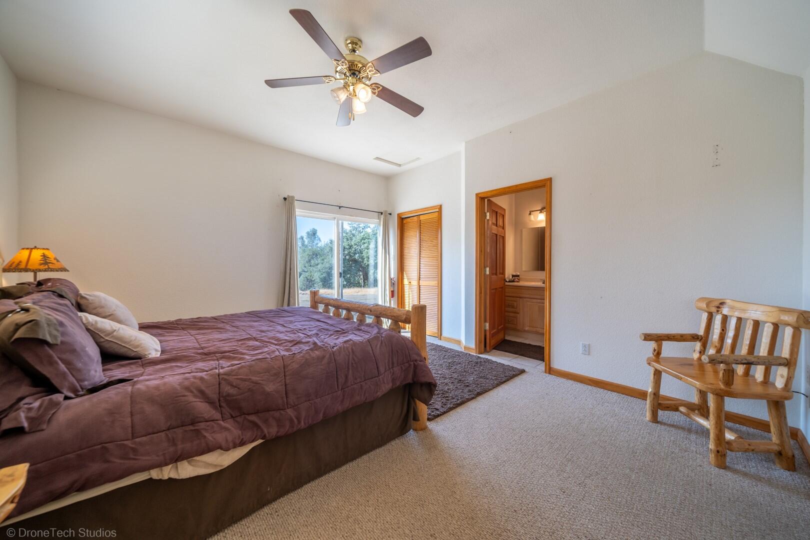 12339 Fern Road Whitmore, CA 96096 - Photo 88 of 152 a bedroom with a bed and a chandelier