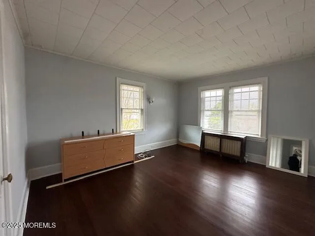 an empty room with furniture and windows
