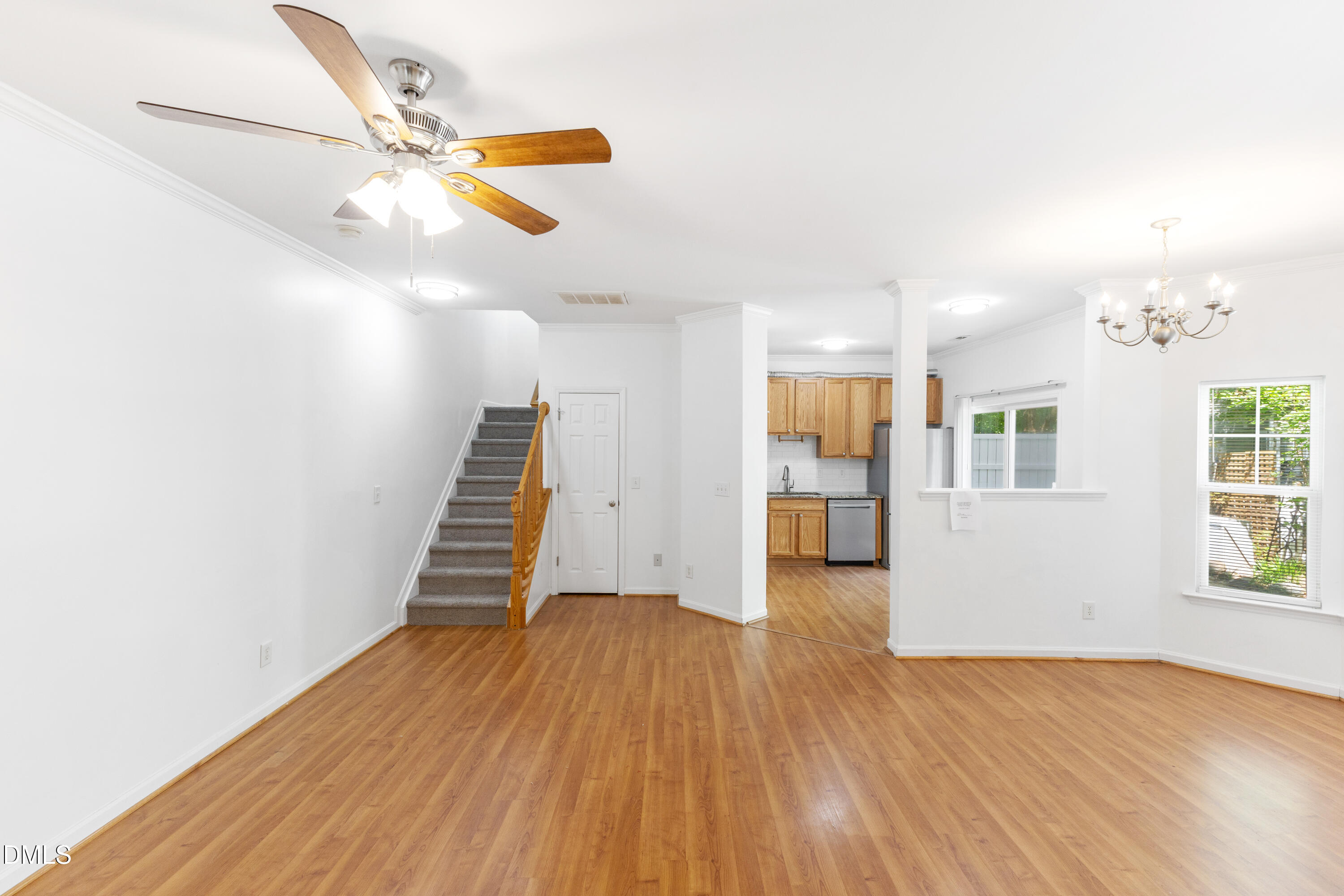 11710 Mezzanine Drive, Unit 101 Raleigh, NC 27614 - Photo 11 of 29 a view of an empty room with wooden floor and a window