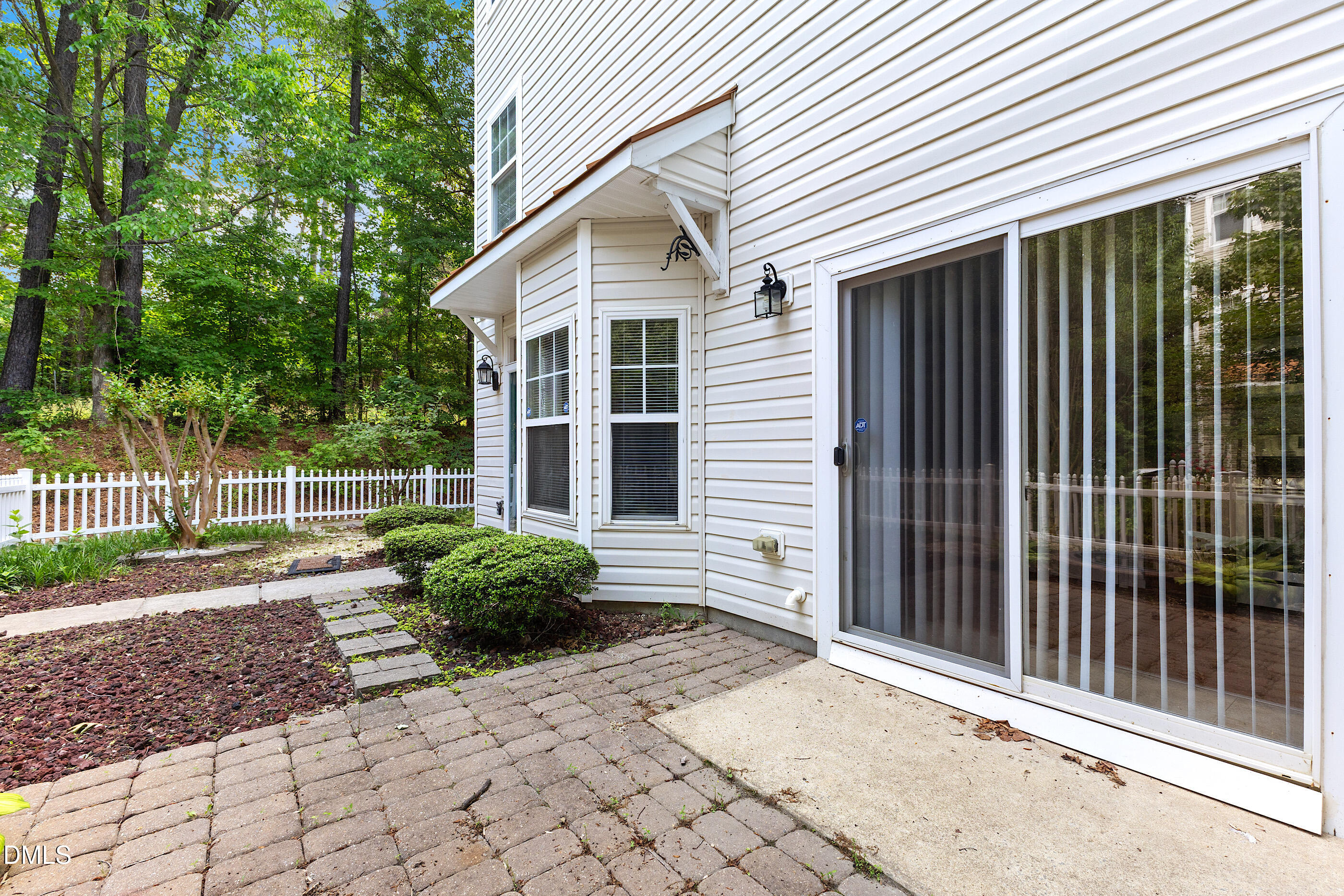 11710 Mezzanine Drive, Unit 101 Raleigh, NC 27614 - Photo 2 of 29 a view of a backyard with plants and wooden fence
