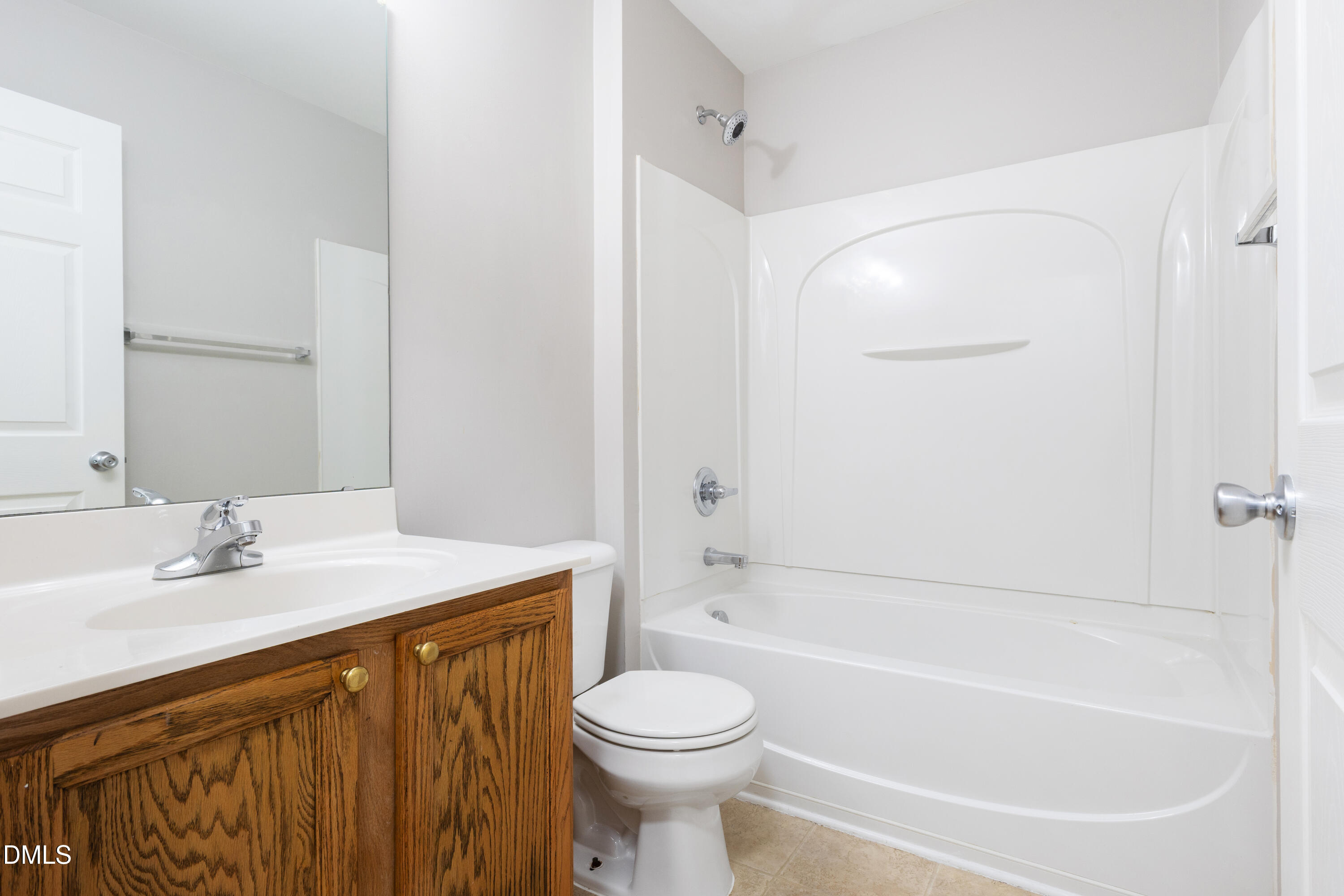 11710 Mezzanine Drive, Unit 101 Raleigh, NC 27614 - Photo 22 of 29 a bathroom with a sink a toilet and a bathtub