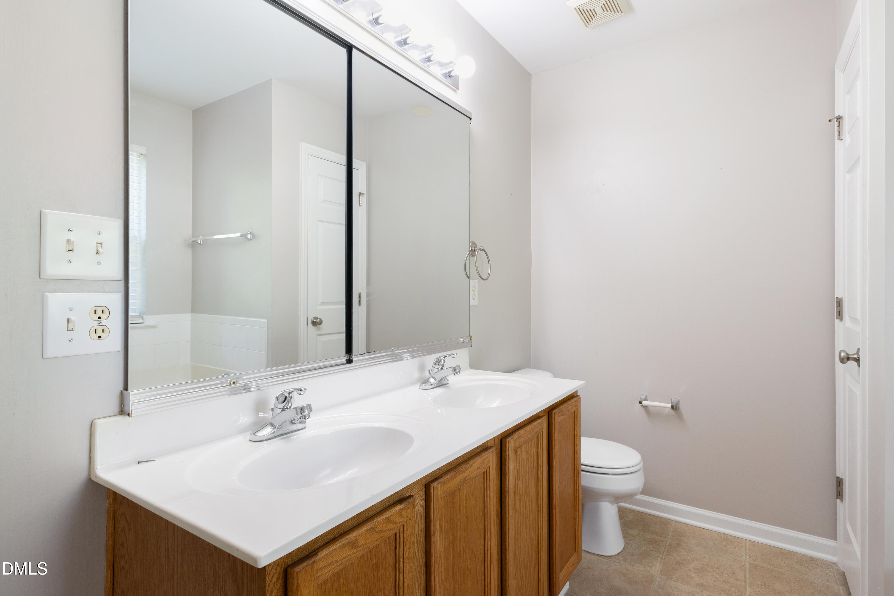 11710 Mezzanine Drive, Unit 101 Raleigh, NC 27614 - Photo 25 of 29 a bathroom with a sink toilet and mirror