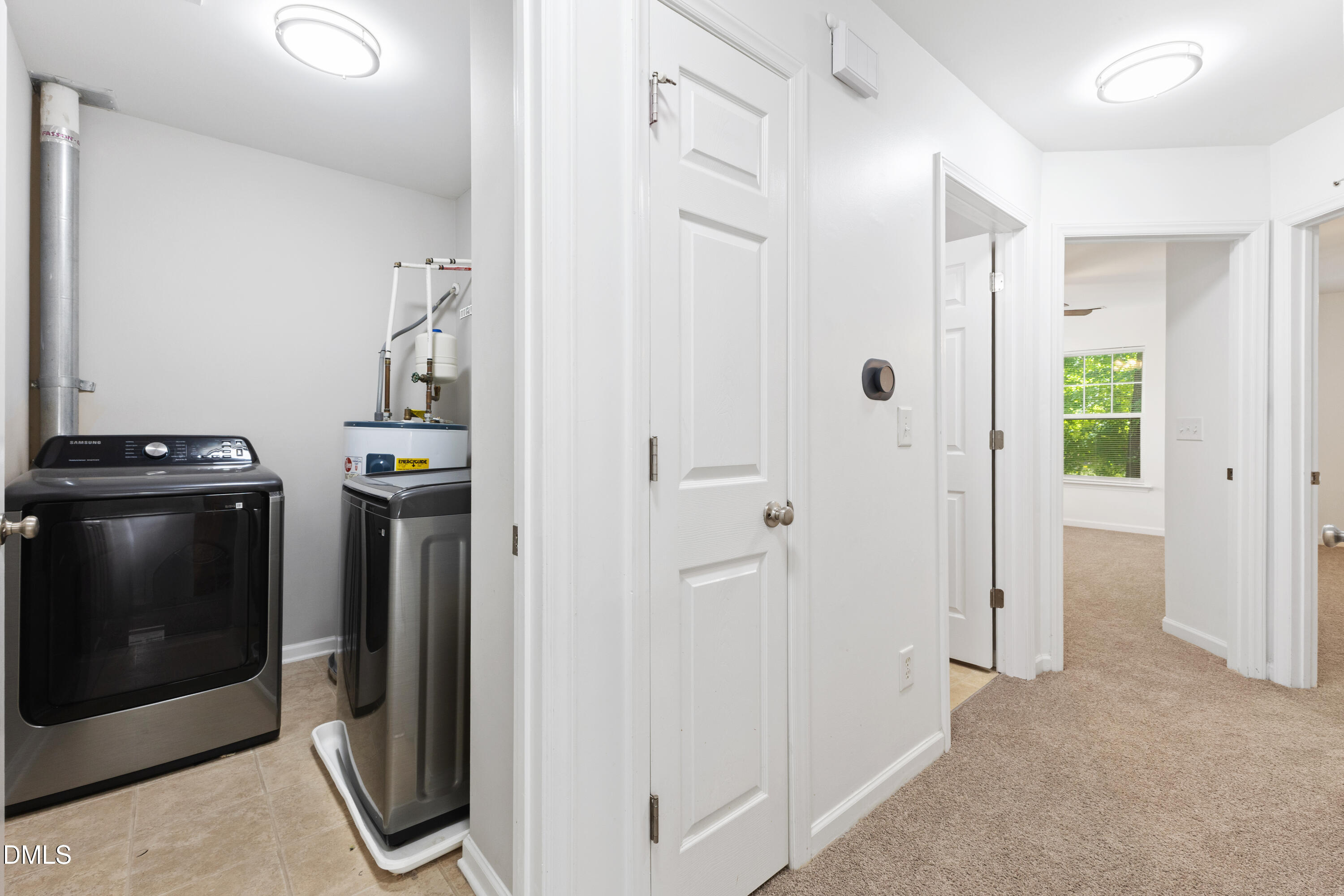 11710 Mezzanine Drive, Unit 101 Raleigh, NC 27614 - Photo 26 of 29 a view of a storage and utility room with washer and dryer