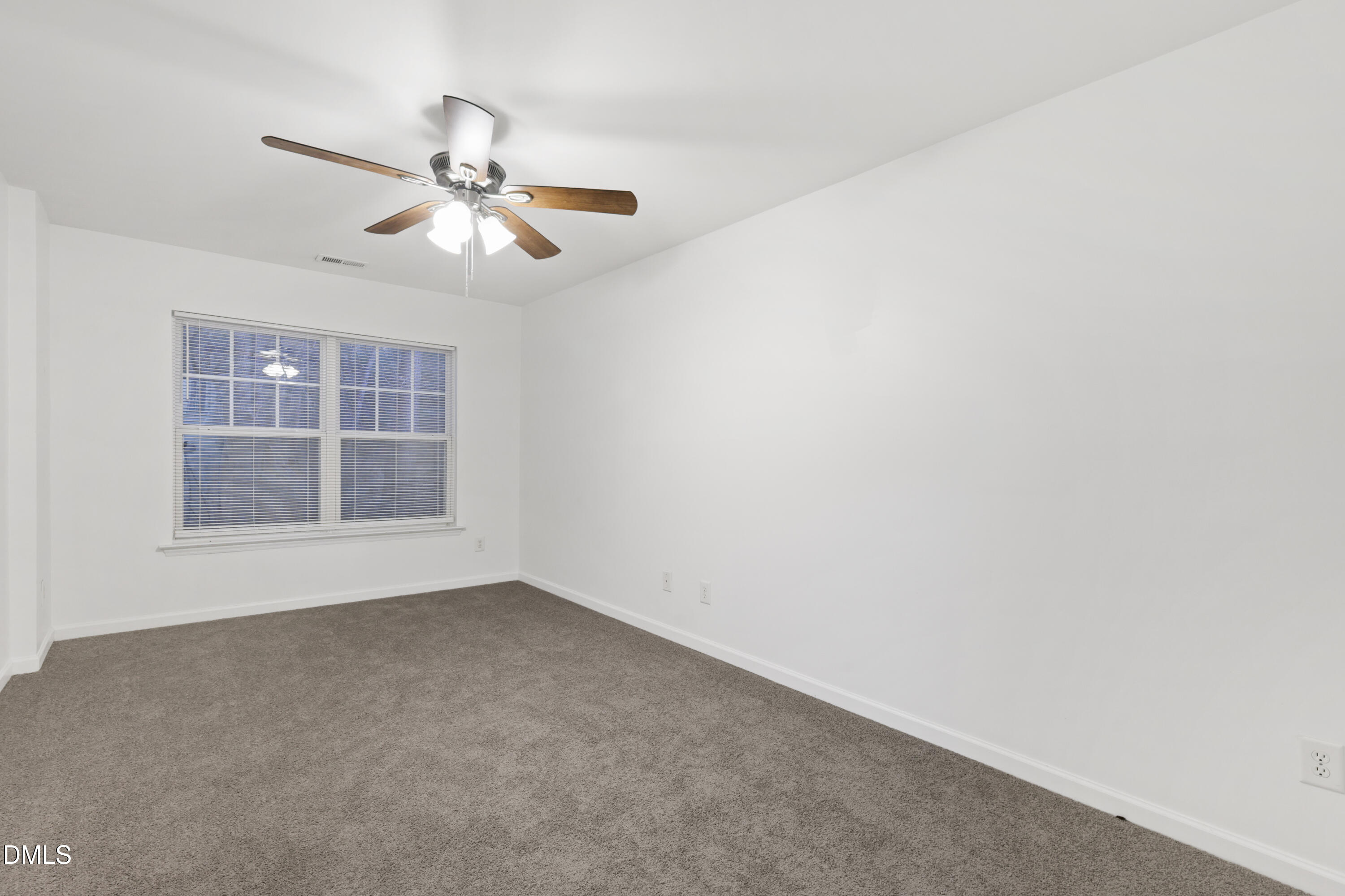 11710 Mezzanine Drive, Unit 101 Raleigh, NC 27614 - Photo 27 of 29 an empty room with windows and fan
