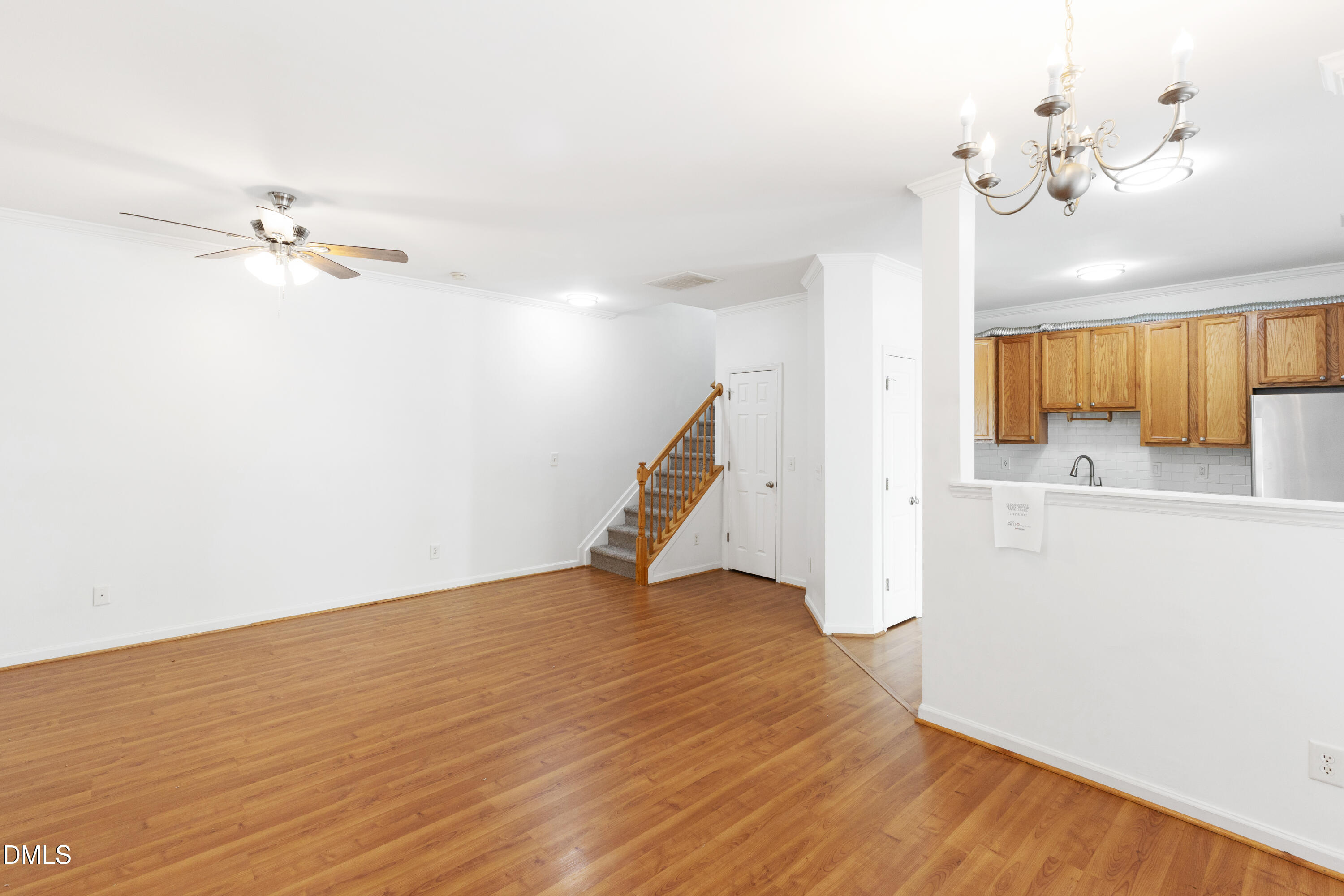 11710 Mezzanine Drive, Unit 101 Raleigh, NC 27614 - Photo 7 of 29 a view of a room with wooden floor and a ceiling fan