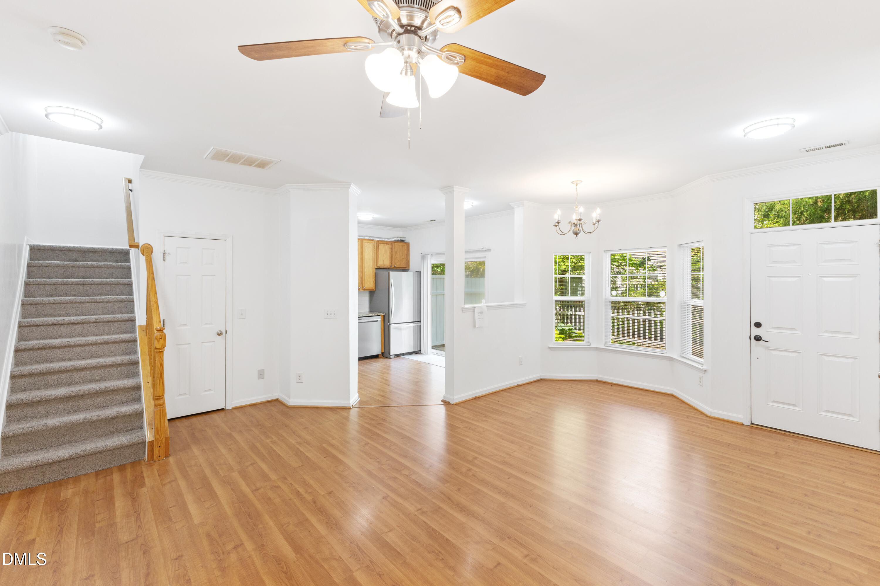 11710 Mezzanine Drive, Unit 101 Raleigh, NC 27614 - Photo 10 of 29 a view of an empty room with wooden floor and a window