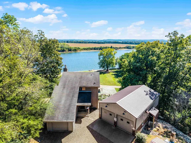 an aerial view of a house with balcony and outdoor space