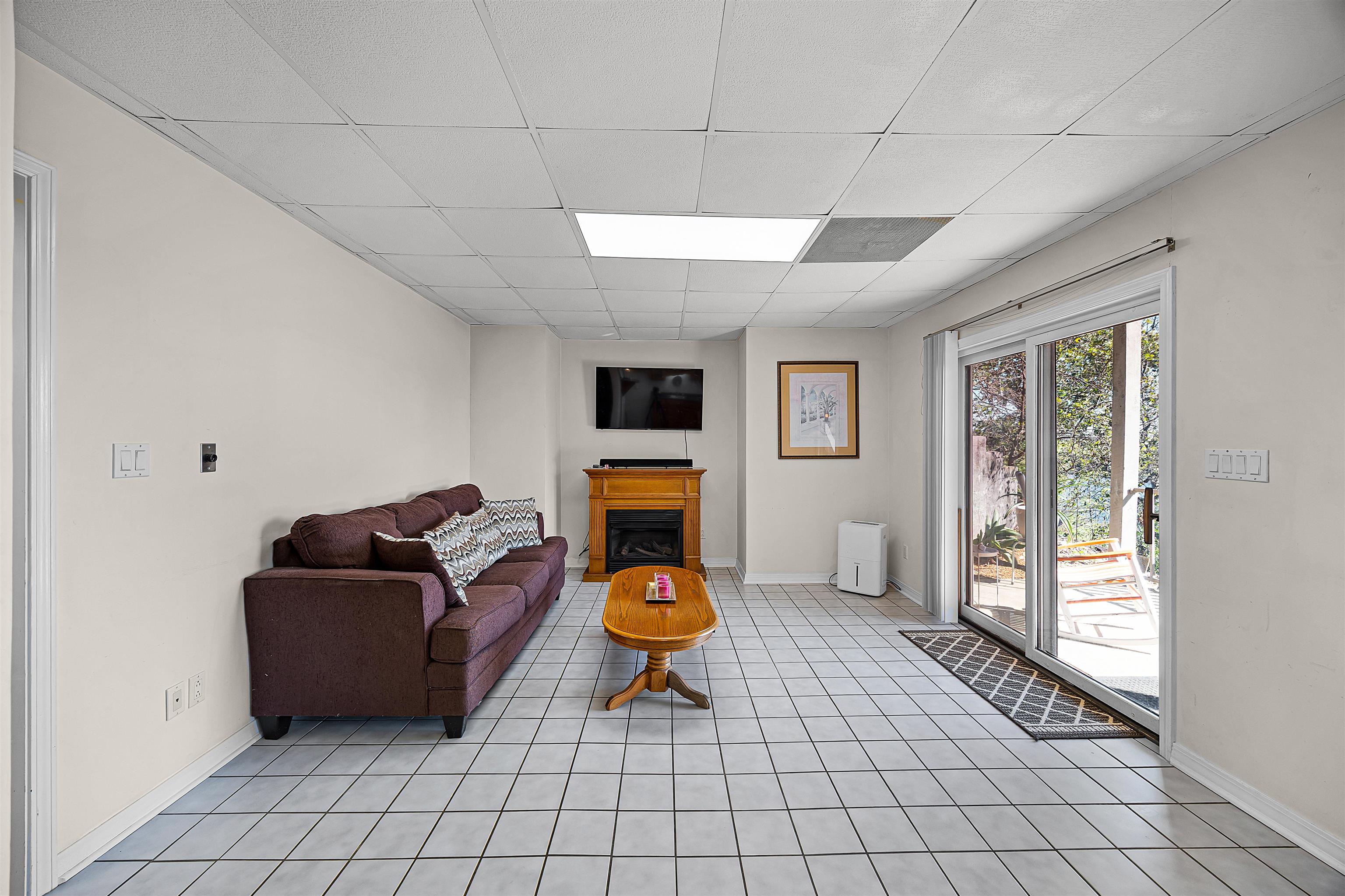 1515 Riverside Lane Adamsville, TN 38310 - Photo 14 of 34 a living room with furniture a flat screen tv and a window