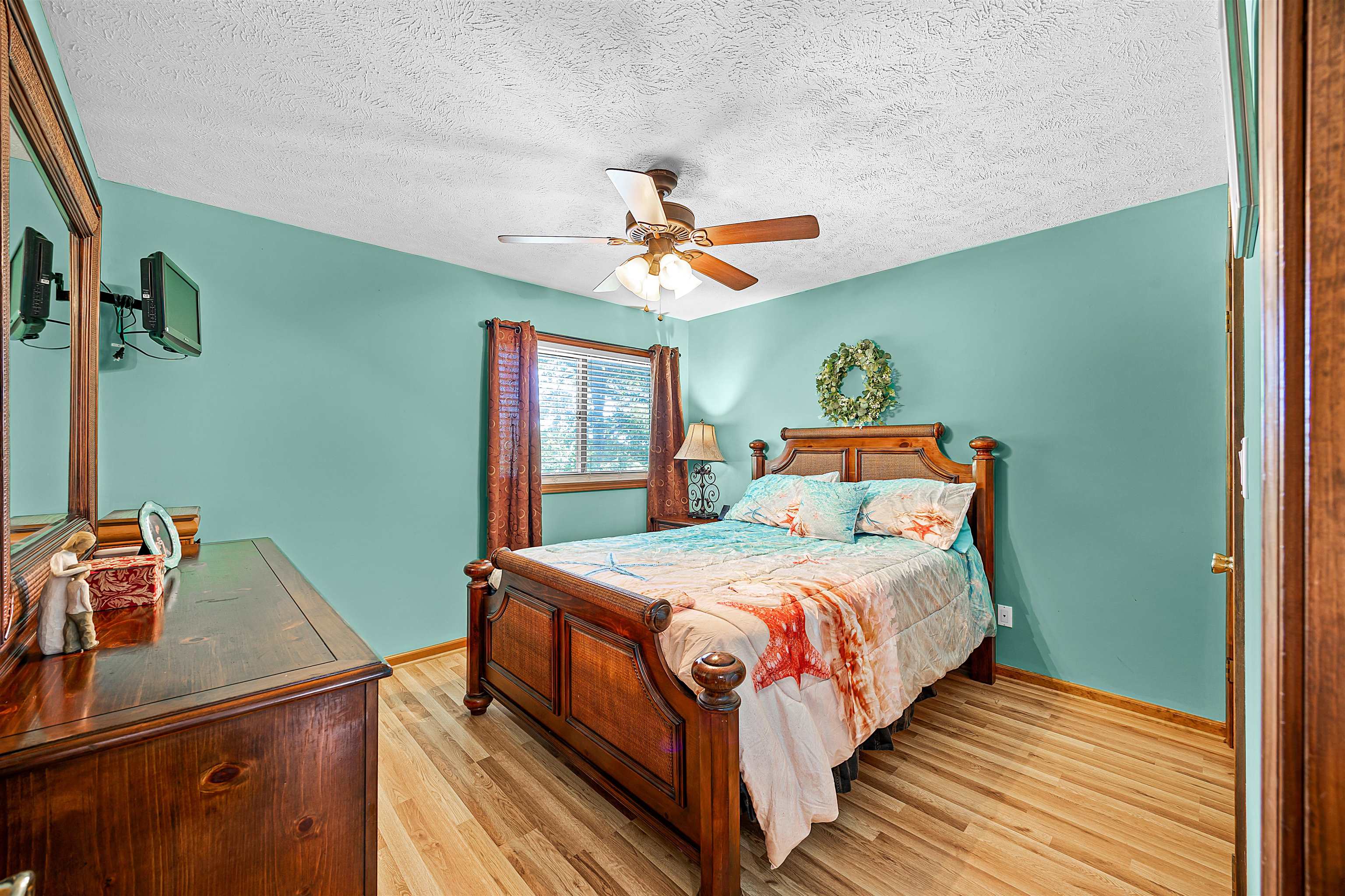 1515 Riverside Lane Adamsville, TN 38310 - Photo 20 of 34 a bedroom with a bed and a chandelier