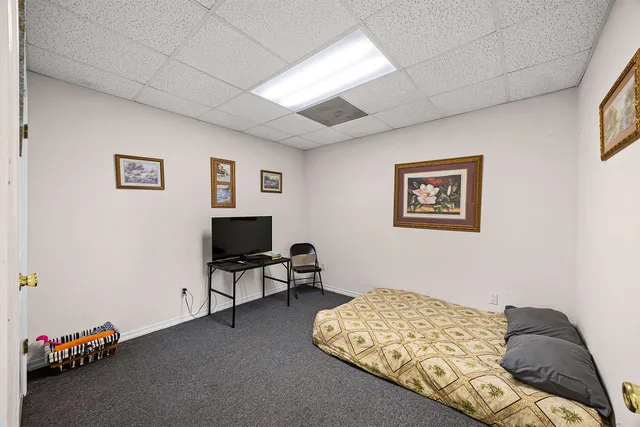 a bedroom with a bed and a chair