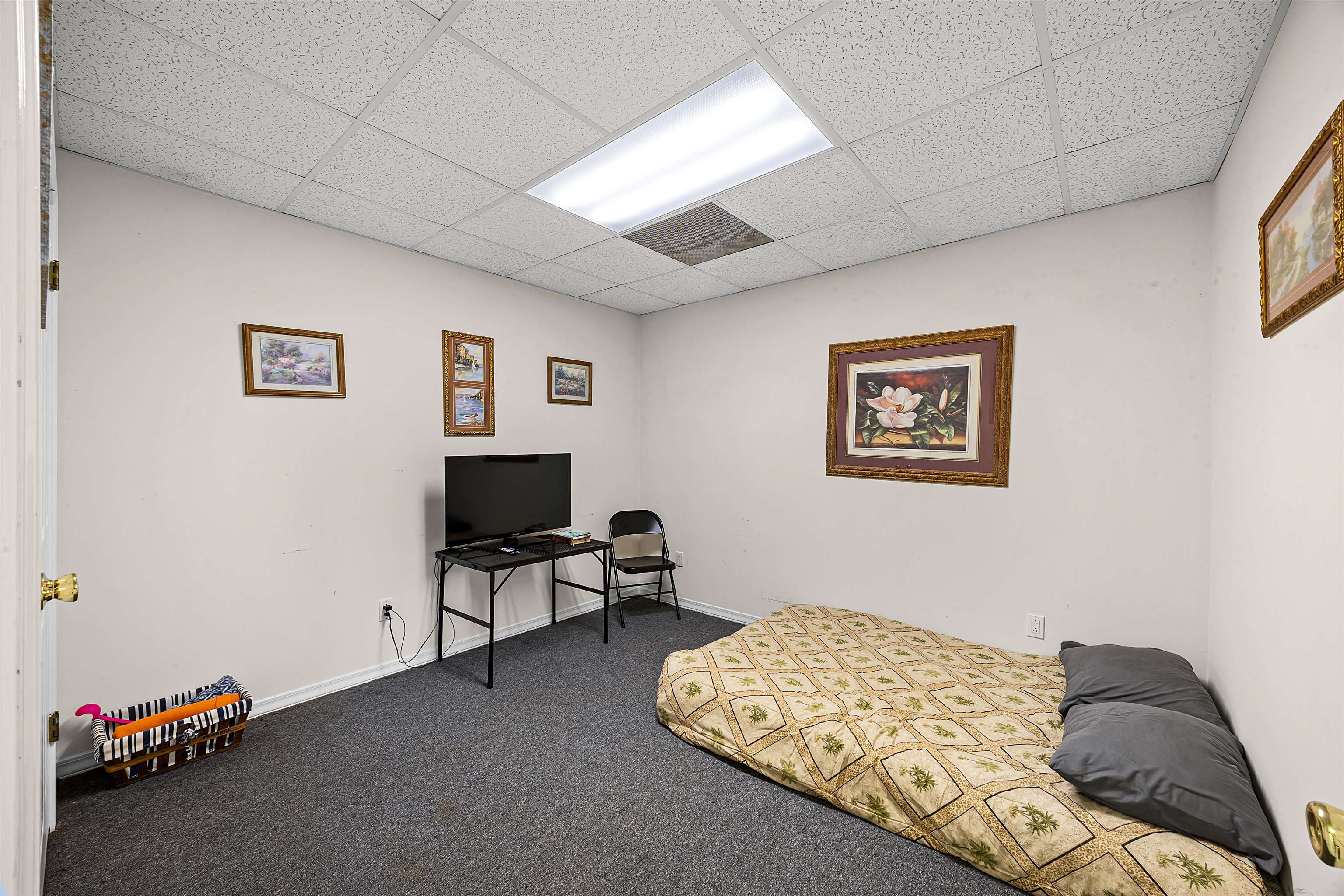 1515 Riverside Lane Adamsville, TN 38310 - Photo 22 of 34 a bedroom with a bed and a chair