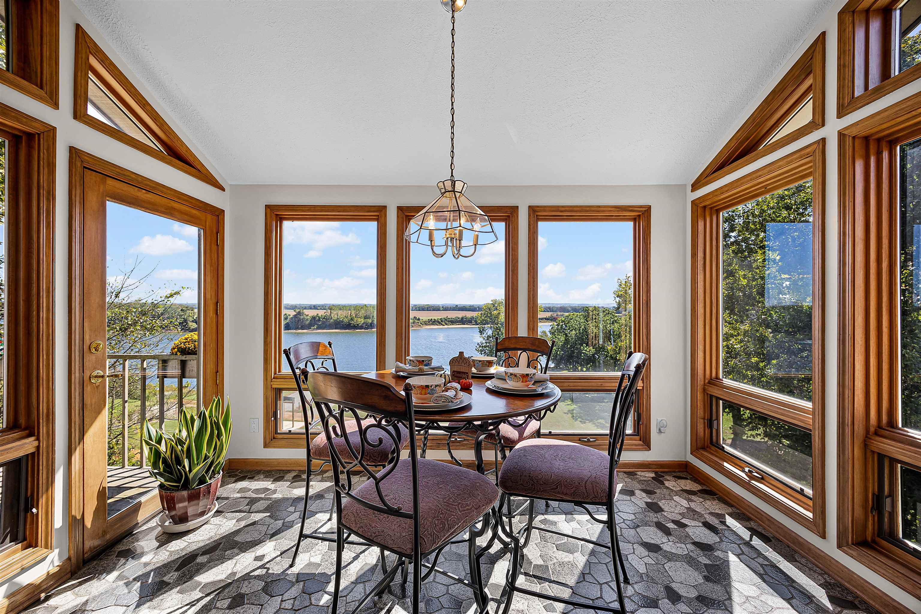 1515 Riverside Lane Adamsville, TN 38310 - Photo 22 of 34 a dining room with furniture water view and a floor to ceiling window