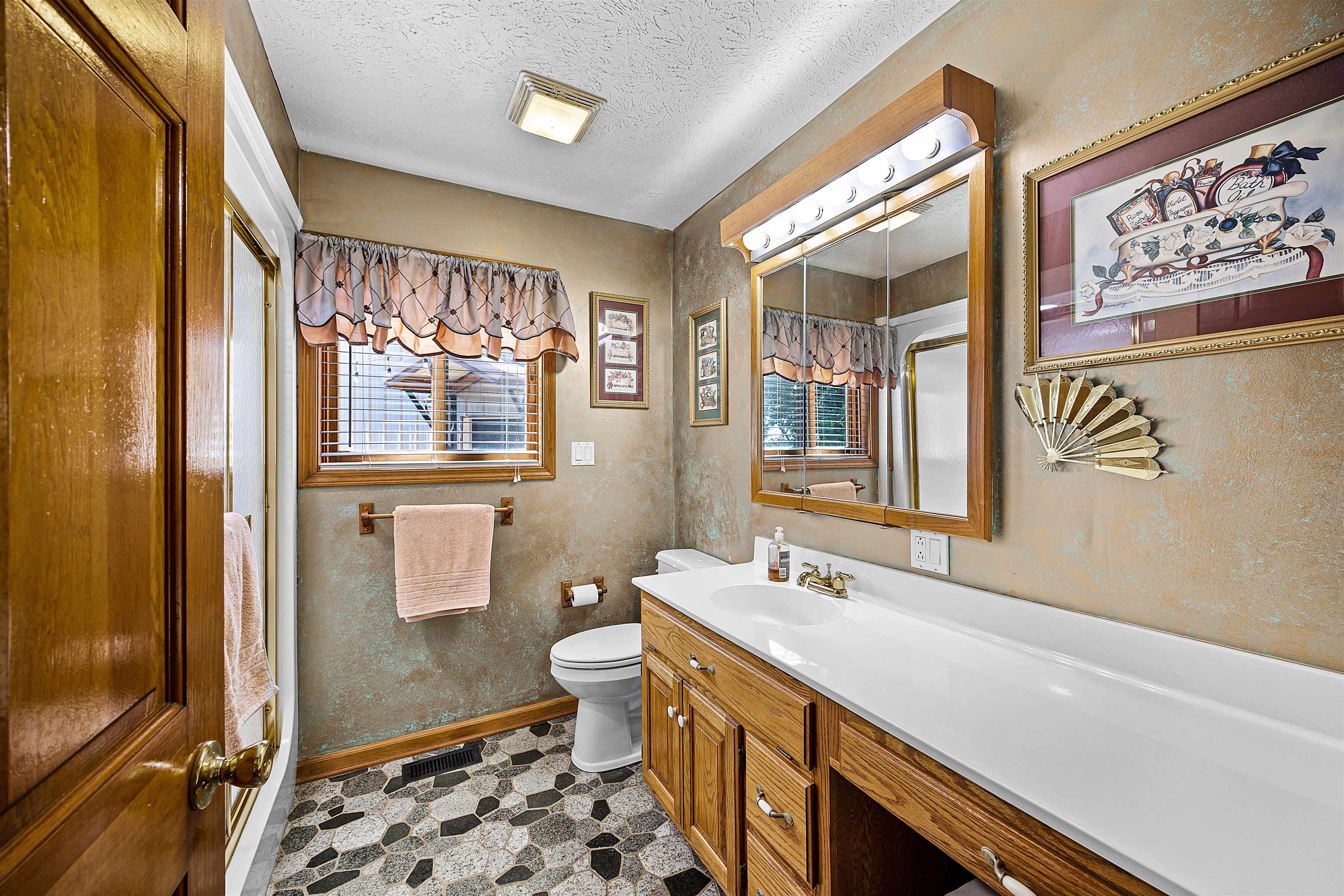 1515 Riverside Lane Adamsville, TN 38310 - Photo 23 of 34 Bathroom with a textured ceiling, vanity, and an enclosed shower