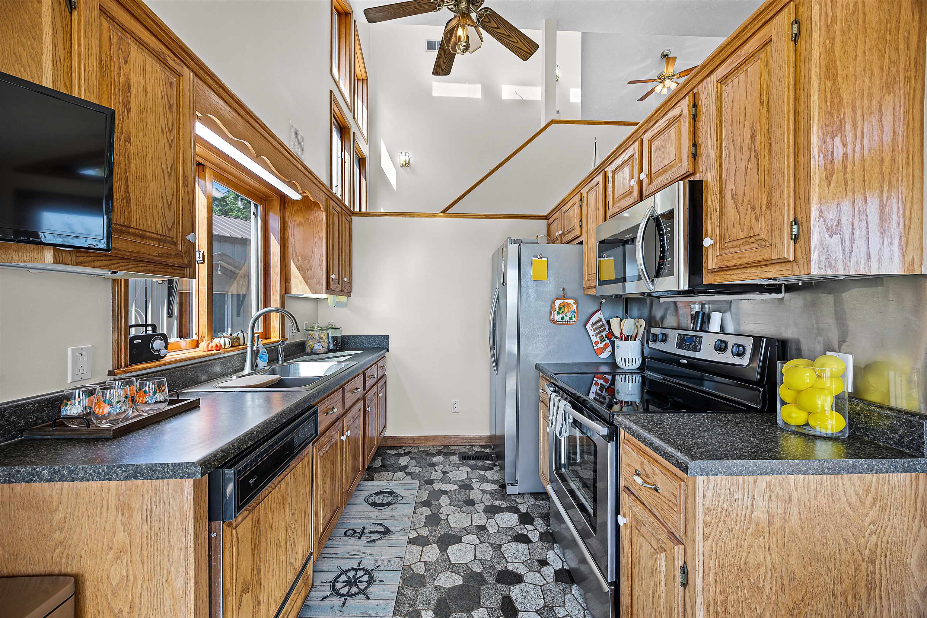 1515 Riverside Lane Adamsville, TN 38310 - Photo 9 of 34 a kitchen with stainless steel appliances granite countertop a stove a sink and a microwave