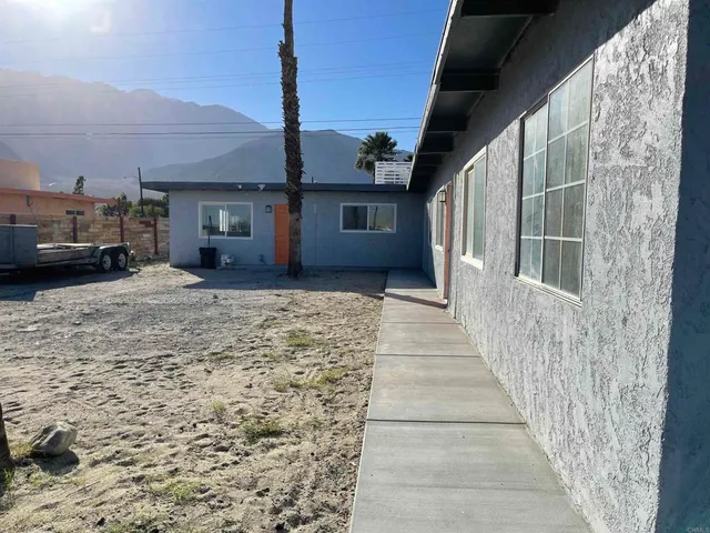 a view of a house with a backyard
