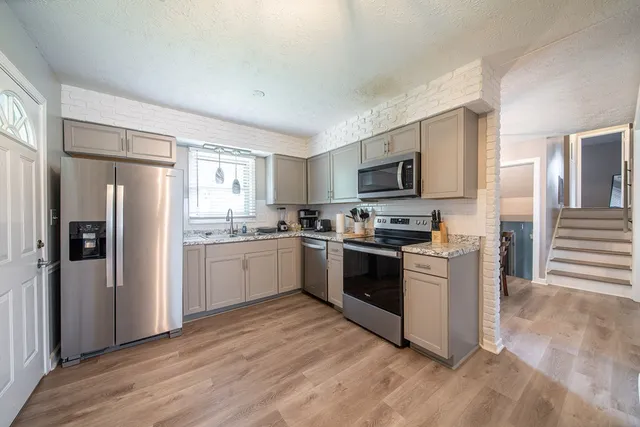 a kitchen with a sink cabinets and stainless steel appliances