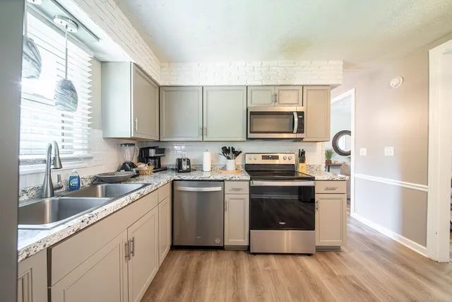 a view of a livingroom with a furniture wooden floor and a window
