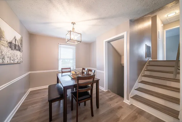a view of a dining room with furniture wooden floor and chandelier