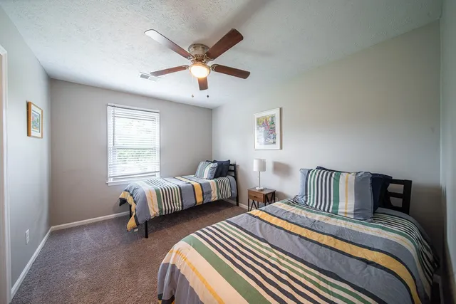 a bedroom with bed and wooden floor