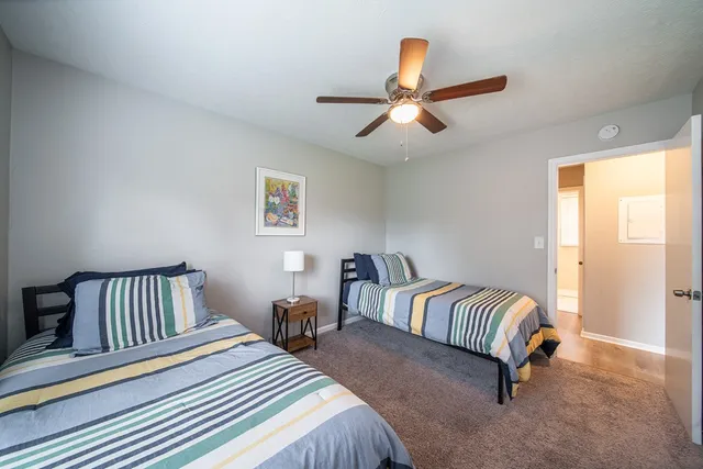 a bedroom with a bed and a large window