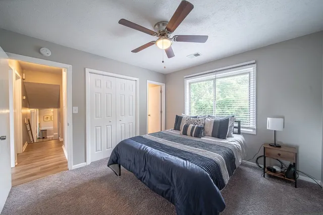 a bed sitting in a bedroom next to a window