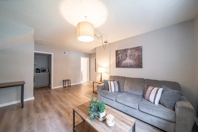a bathroom with a toilet a sink and a large mirror