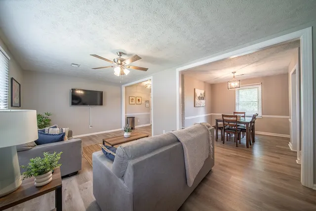 a living room with furniture and a flat screen tv