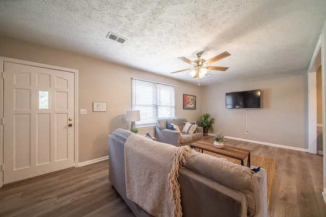 a living room with furniture and kitchen view