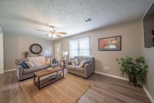 a kitchen with granite countertop a refrigerator stove and sink