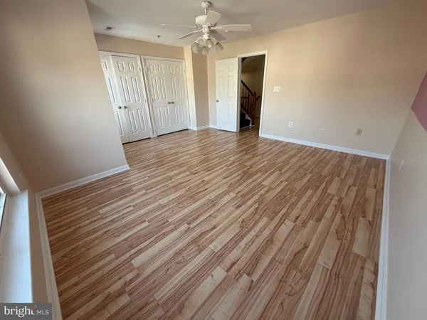 a view of a room with wooden floor
