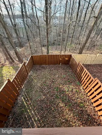 a view of balcony with wooden floor and fence